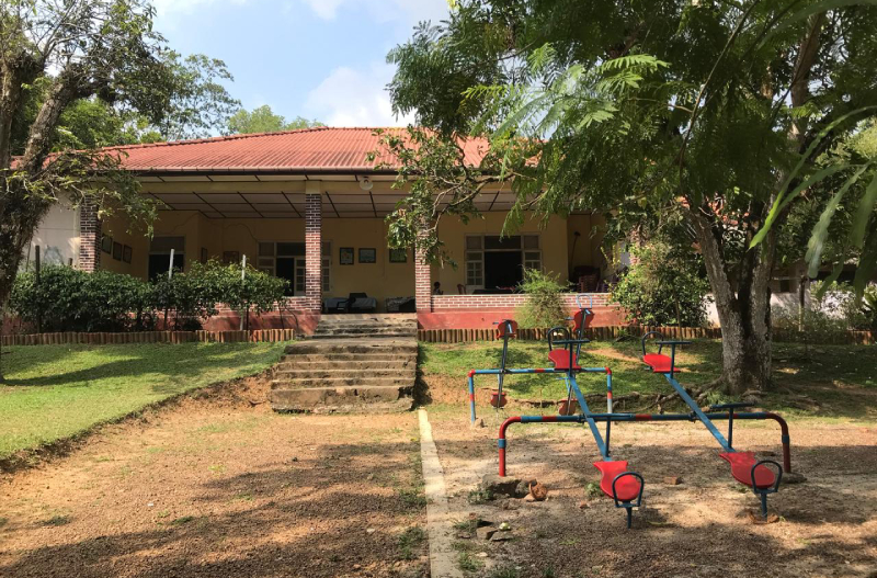 A caregiver and child in a heritage building